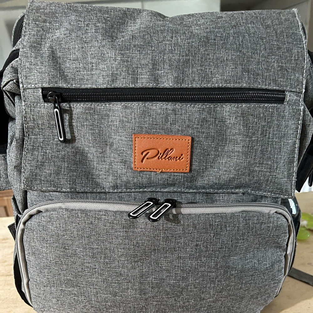 Diaper bag with changing station